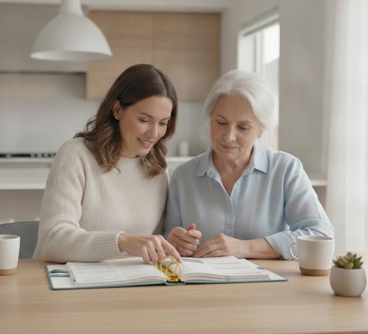 Adult daughter helping her mother organize appointments, medications, and healthcare information using My Health Journal, a nurse designed linen health journal for patients and caregivers.